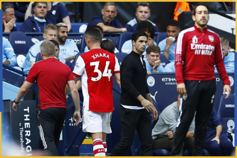 Soccer Football - Premier League - Manchester City v Arsenal - Etihad Stadium, Manchester, Britain - August 28, 2021 Arsenal's Granit Xhaka walks off the pitch after being shown a red card as manager Mikel Arteta looks on Action Images via Reuters/Jason Cairnduff EDITORIAL USE ONLY. No use with unauthorized audio, video, data, fixture lists, club/league logos or 'live' services. Online in-match use limited to 75 images, no video emulation. No use in betting, games or single club /league/player publications. Please contact your account representative for further details.