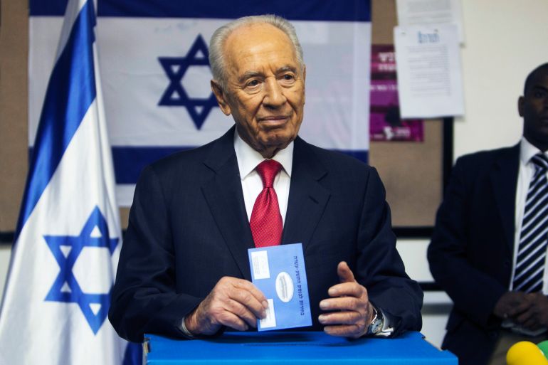 Israel's President Peres casts his ballot as he votes in the parliamentary election at a polling station in Jerusalem