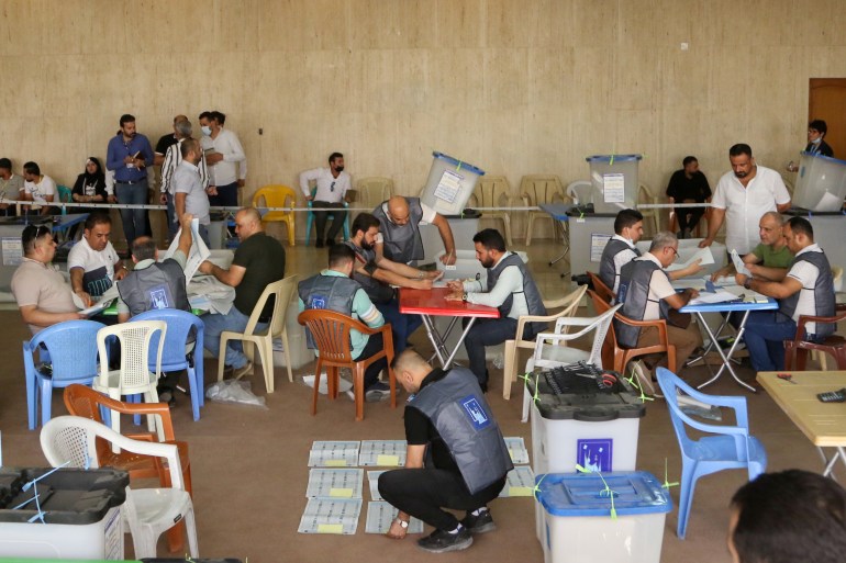 Employees of Iraq's Independent High Electoral Commission count votes at the Green Zone in Baghdad