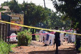 Ugandan police members and explosives experts secure the scene of an explosion in Komamboga, on the northern outskirts of Kampala