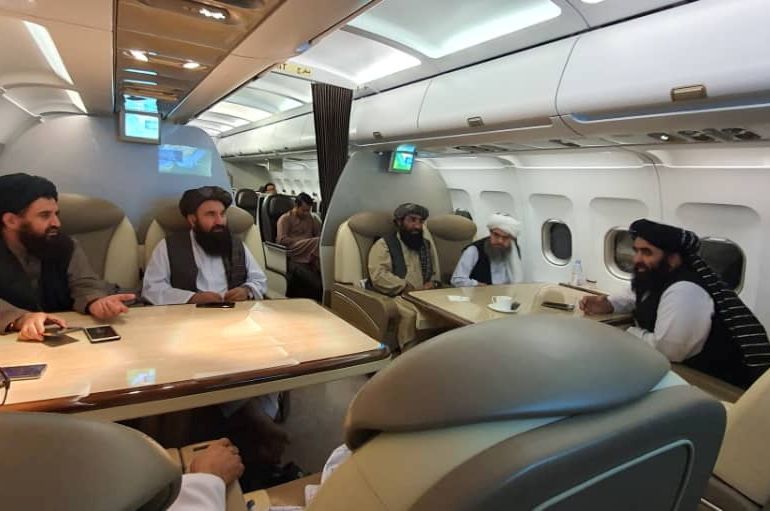 Taliban delegates are seated in a plane in an unidentified location, in this handout photo uploaded to social media on October 9, 2021. Picture uploaded on on October 9, 2021. Social media handout/via REUTERS ATTENTION EDITORS - THIS IMAGE HAS BEEN SUPPLIED BY A THIRD PARTY. NO RESALES. NO ARCHIVES.
