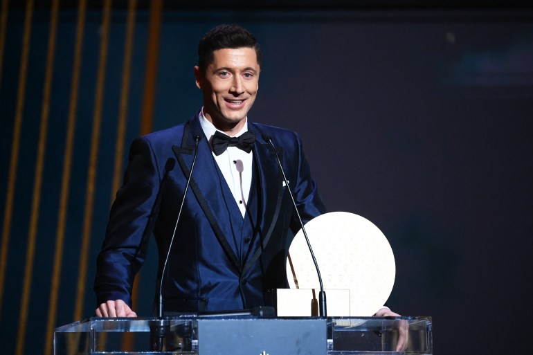 Bayern Munich's Polish forward Robert Lewandowski delivers a speech after receiving the Striker of the Year award during the 2021 Ballon d'Or France Football award ceremony at the Theatre du Chatelet in Paris on November 29, 2021. (Photo by FRANCK FIFE / AFP)