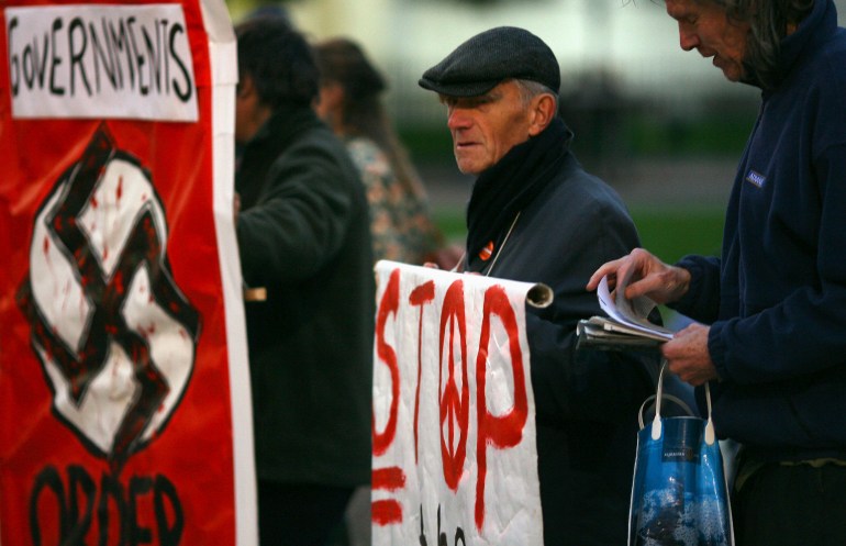 Demonstrators from Stop the War Coalition stand outside the Houses of Parliament in London