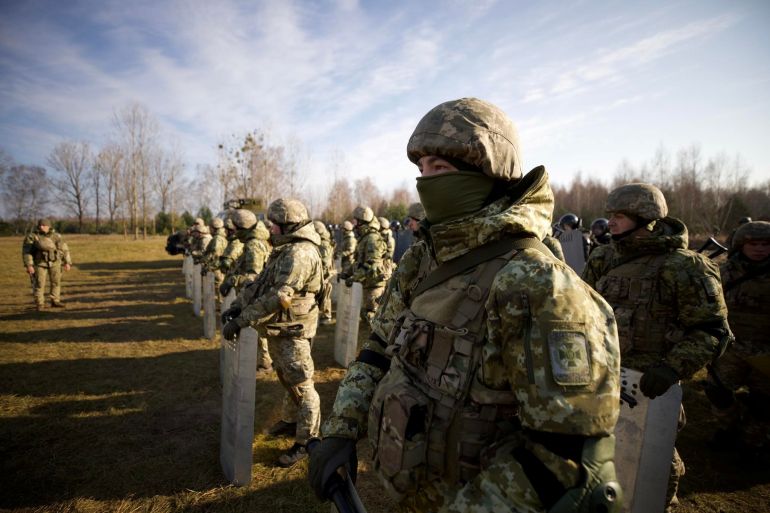 Ukrainian borderguards line up at the border with Belarus in Volyn region