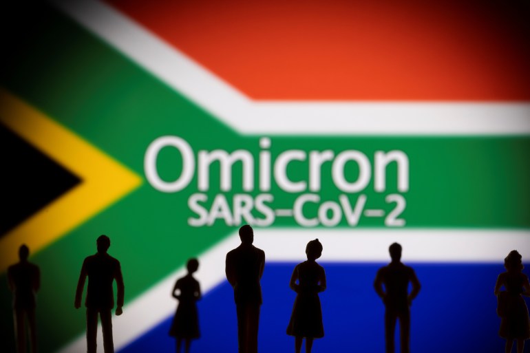 Small toy figures are seen in front of a displayed South Africa flag and words "Omicron SARS-CoV-2" in this illustration taken