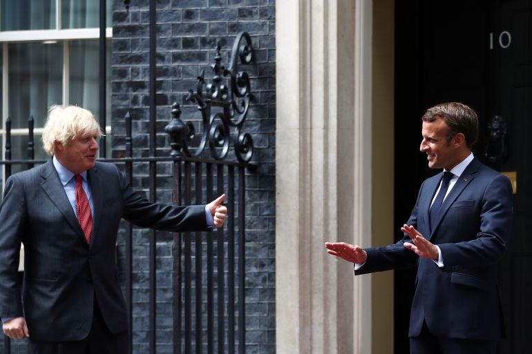 Britain's Prime Minister Boris Johnson and French President Emmanuel Macron gesture as they meet at Downing Street in London, Britain, June 18, 2020. REUTERS/Hannah McKay/Pool
