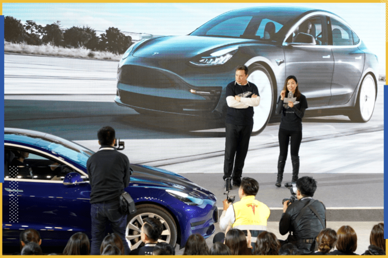 Tesla Inc CEO Elon Musk and Grace Tao, Tesla's vice president for external relations, attend a delivery ceremony for the electric vehicle (EV) maker's China-made Model 3 cars in Shanghai, China January 7, 2020. Picture taken January 7, 2020. REUTERS/Aly Song