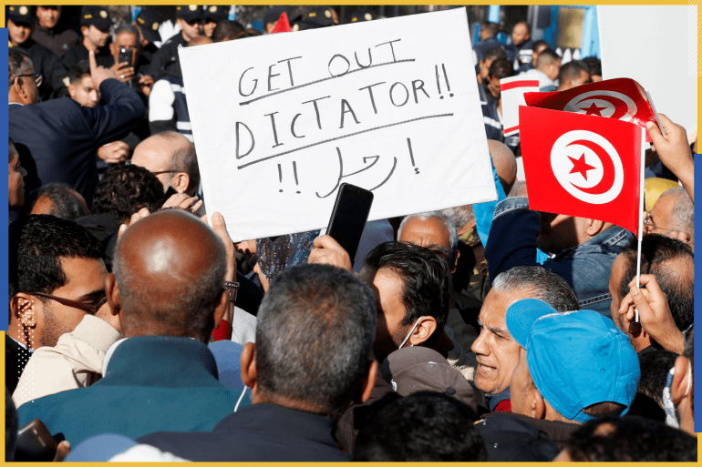 Demonstrators carry flags and placards during a protest against Tunisian President Kais Saied's seizure of governing powers, in front of the parliament, in Tunis, Tunisia, November 14, 2021. REUTERS/Zoubeir Souissi