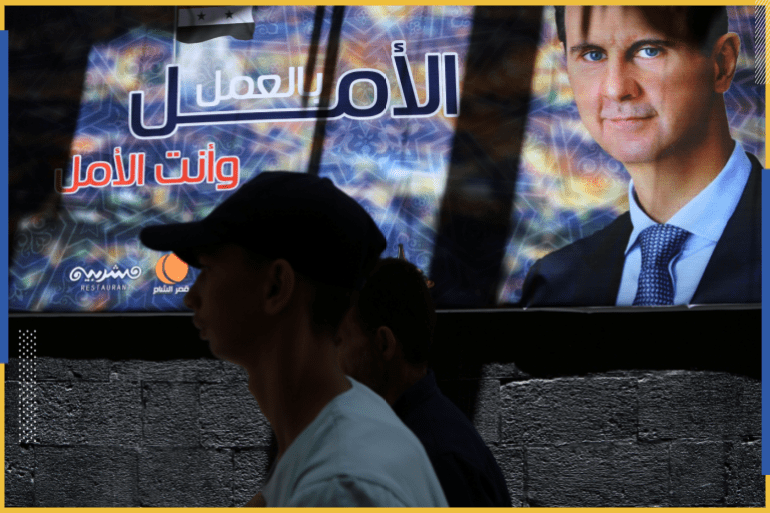 A man walks past a banner depicting Syria's President Bashar al-Assad, ahead of the May 26 presidential election, in Damascus, Syria May 22, 2021. Picture taken May 22, 2021. The Arabic reads "Hope through work". REUTERS/Yamam al Shaar