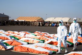 Flag-draped soldiers, killed during an attack on the army camp on the Niger- Mali border, are displayed during their burial ceremony at military airport in Niamey