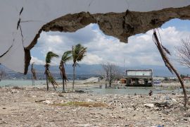 Ruins and damaged building are pictured nearly one year after an earthquake and tsunami at a beach in Palu