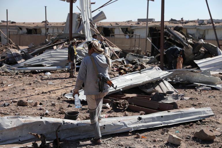 Guard inspects damage at a workshop hit by Saudi-led airstrikes in Sanaa