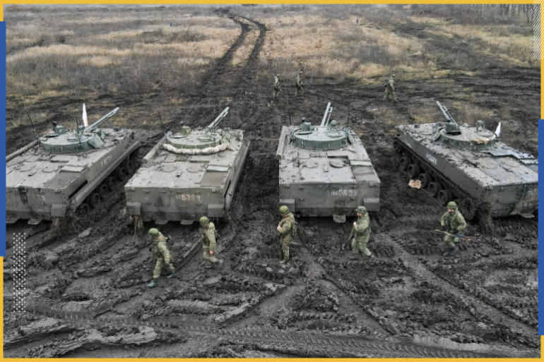 Russian service members walk past BMP-3 infantry fighting vehicles during tactical combat exercises held by a motorised rifle division at the Kadamovsky range in the Rostov region, Russia December 10, 2021. Picture taken with a drone. REUTERS/Sergey Pivovarov