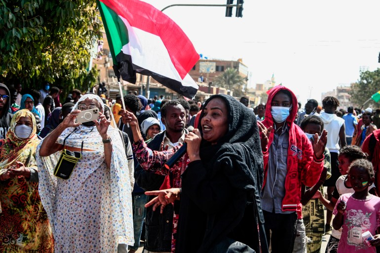 A Sudanese woman speaks during in a rally to protest against last year's military coup, in the capital Khartoum, on January 30, 2022. - The October 25 coup led by General Abdel Fattah al-Burhan, which derailed a civilian-military power-sharing deal negotiated in the wake of the 2019 ouster of autocrat Omar al-Bashir. (Photo by AFP)