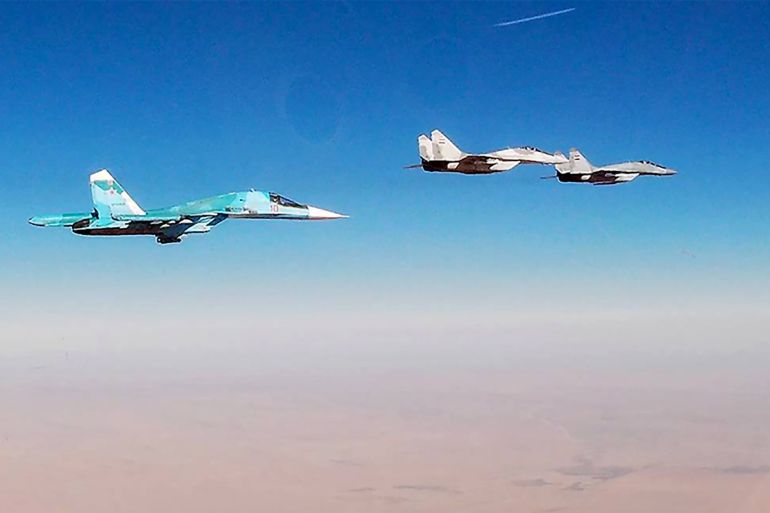 1237947968 Russian and Syrian military pilots jointly patrol Syrias airspace SYRIA JANUARY 22, 2022: Pictured in this image dated 22 January 2022 is a Russian Air Force Sukhoi Su-34 strike aircraft (L) and a Syrian Air Force Mikoyan MiG-29 fighter aircraft in flight. Russian and Syrian military pilots departed from Hmeimim, Saikal and Dumayr air bases to conduct their first joint air patrols along the Golan Heights and the Euphrates River. Russian Air Force crews piloted Sukhoi Su-34 strike aircraft, Sukhoi Su-35 fighter aircraft and a Beriev A-50 airborne early warning and control aircraft, while the Syrian side piloted Mikoyan Mig-23 and Mikoyan Mig-29 fighter aircraft for the patrol missions. Russian Defence Ministry/TASS THIS IMAGE WAS PROVIDED BY A THIRD PARTY. EDITORIAL USE ONLY (Photo by Russian Defence Ministry\TASS via Getty Images)