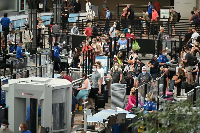 Passengers waiting to go through security at Denver International Airport earlier this year.Credit...Hyoung Chang/MediaNews Group, via The Denver Post, via Getty Images