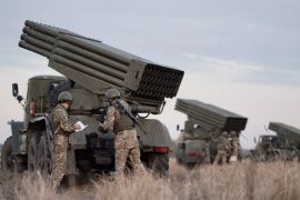Service members of the Ukrainian Armed Forces gather near BM-21 "Grad" multiple rocket launchers during tactical military exercises at a shooting range in the Kherson region, Ukraine, January 19, 2022. Picture taken January 19, 2022. Ukrainian Defence Ministry/Handout via REUTERS ATTENTION EDITORS - THIS IMAGE HAS BEEN SUPPLIED BY A THIRD PARTY.