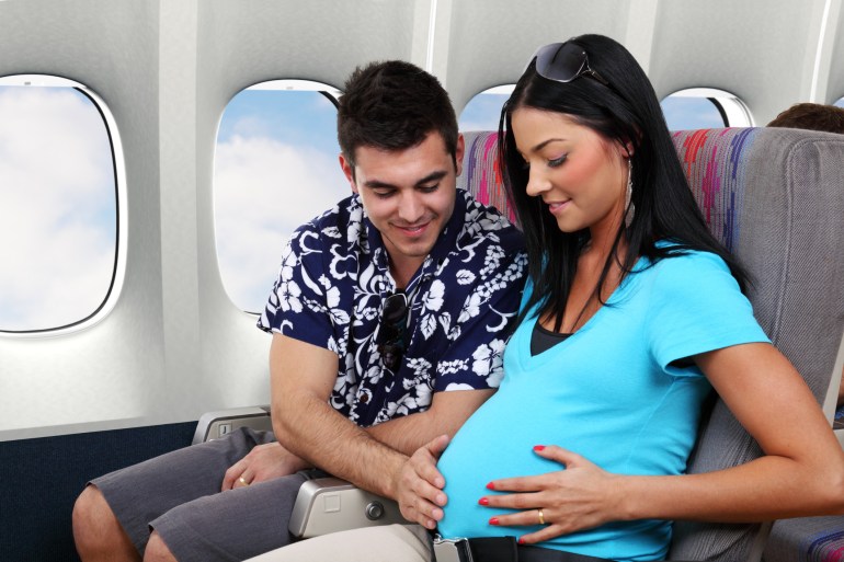 woman pregnant - plane
