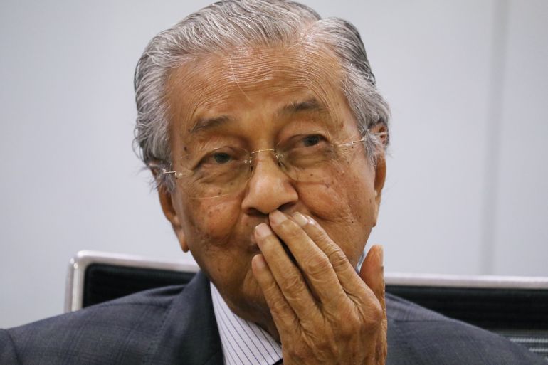 Malaysia's former Prime Minister Mahathir Mohamad reacts during a news conference in Kuala Lumpur