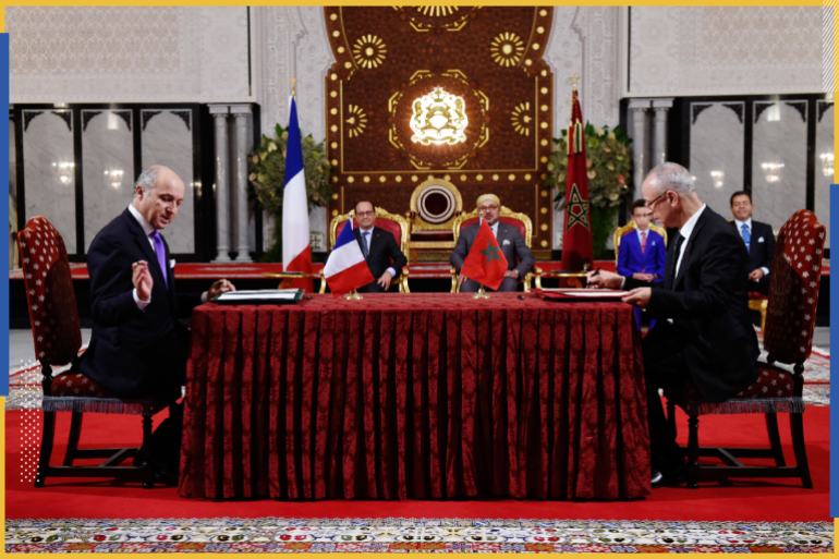 French Foreign Affairs minister Laurent Fabius (L) and Moroccan minister of religious affairs Ahmed Toufik (R) sign documents as part of a bilateral agreement on the training of French imams at the Marchane Palace in the port city of Tangier, Morocco. French President Francois Hollande (2ndL) and Morocco's King Mohammed VI (2ndR) attend the ceremony. REUTERS/Alain Jocard/Pool
