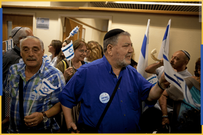 TEL AVIV, ISRAEL - JULY 16: (ISRAEL OUT) An estimated 400 new French Jewish immigrants wave Israeli flags during a welcoming ceremony after arriving on a flight from France on July 16, 2014 at Ben Gurion airport near Tel Aviv, Israel. Today Israel reportedly issued a warning to 100,000 residents of northern Gaza to evacuate their homes as it continues with planned airstrikes as part of operation 'Protective Edge'. Israeli Prime Minister Benjamin Netanyahu said he had 'no choice' but to expand and intensify the military operation in light of the refusal to ceasefire terms from Hamas officials. (Photo by Lior Mizrahi/Getty Images)