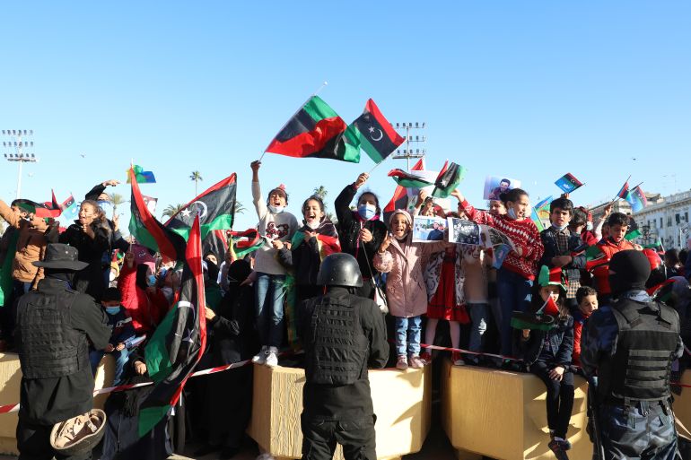 People wave Libyan flags as they gather during celebrations commemorating the 10th anniversary of the 2011 revolution in Tripoli, Libya February 17, 2021. REUTERS/Hazem Ahmed