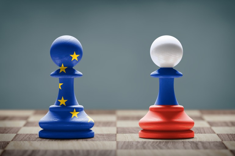 European Union and Russia conflict. Flags on chess pawns on a chess board.