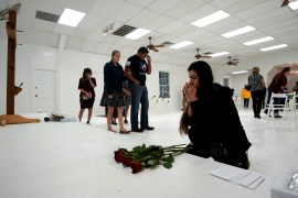 A woman prays in the First Baptist Church of Sutherland Springs following the shooting attack in Texas