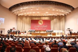 Iraqi lawmakers attend the first session of the new Iraqi parliament in Baghdad
