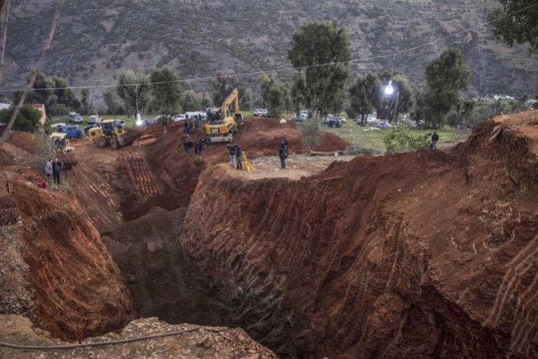 Rescuers are using heavy machinery to dig a hole parallel to the well where a boy, named locally as Rayan, is stuck AP
