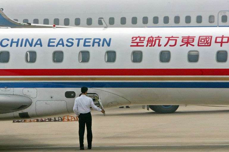 A worker checks a China Eastern aircraft at Hong Qiao airport in Shanghai April 11, 2006. China Eastern Airlines Corp. Ltd. said on Tuesday it had agreed to buy sixteen Boeing 737 NG series aircraft with a catalogue value of $924 million. REUTERS/Aly Song