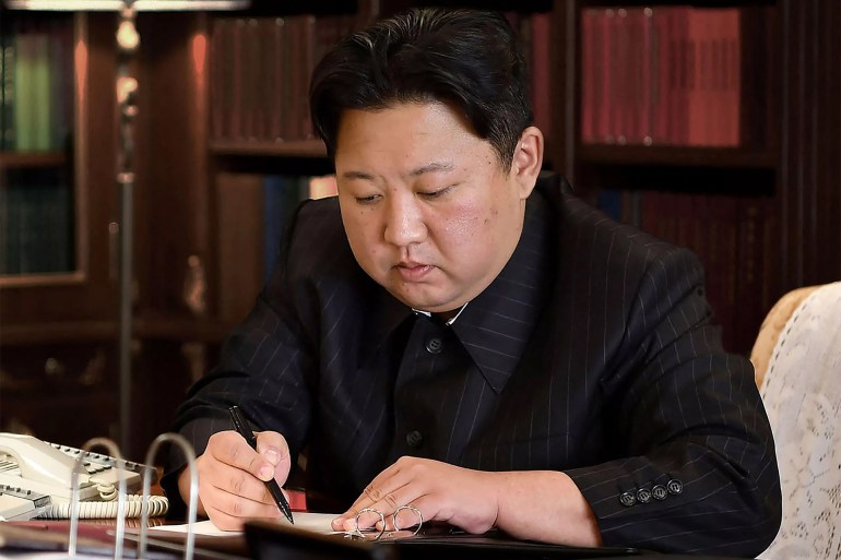 The North Korean leader is seen writing the order for a test launch of a new type of ICBM in a picture released from North Korea's official Korean Central News Agency