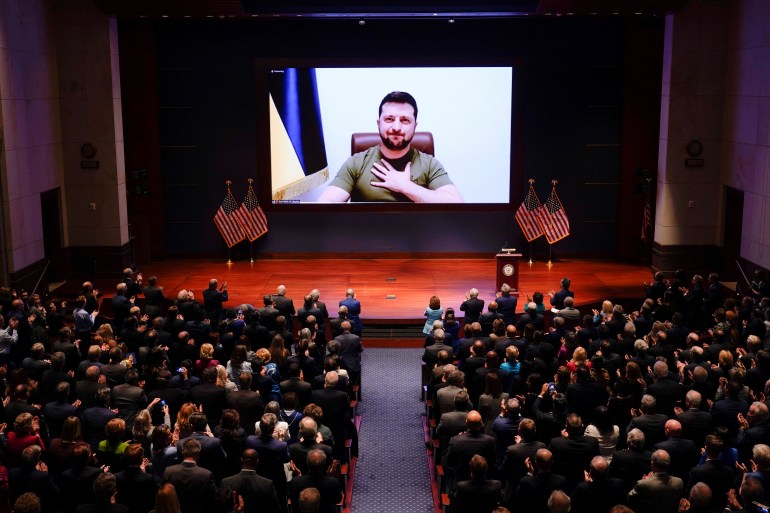 Ukrainian President Volodymyr Zelenskiy delivers a video address to senators and members of the House of Representatives gathered in the Capitol Visitor Center Congressional Auditorium, at the U.S. Capitol in Washington, U.S., March 16, 2022. J. Scott Applewhite/Pool via REUTERS