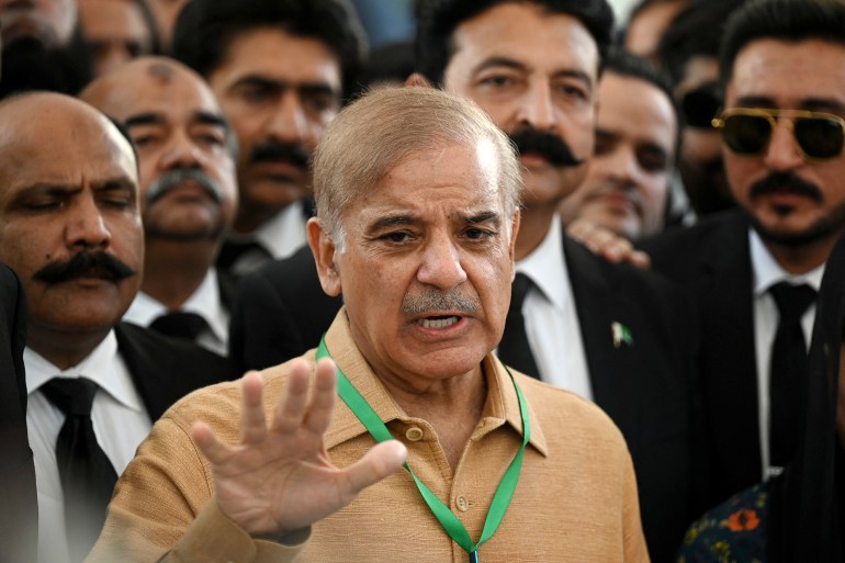 Pakistan's opposition leader Shehbaz Sharif (C) speaks with the media before attending a hearing outside the Supreme Court building in Islamabad on April 7, 2022. (Photo by Aamir QURESHI / AFP)