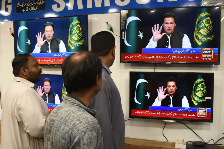 People watch Prime Minister of Pakistan Imran Khan addressing the nation