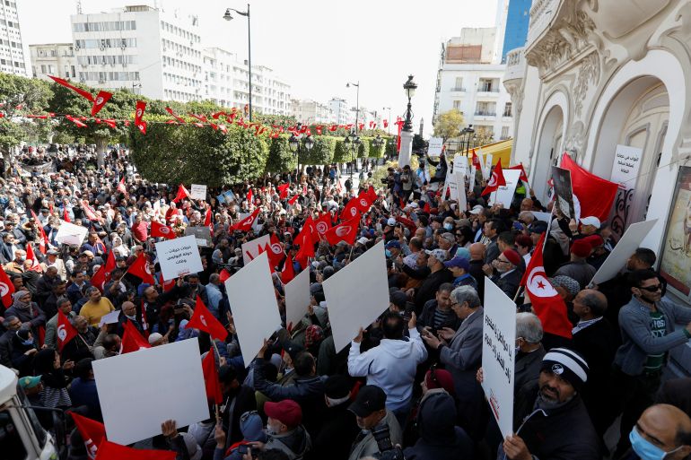 Demonstrators carry banners and flags during a protest against Tunisian President Kais Saied after he dissolved the parliament last month, in Tunis, Tunisia April 10, 2022. REUTERS/Zoubeir Souissi