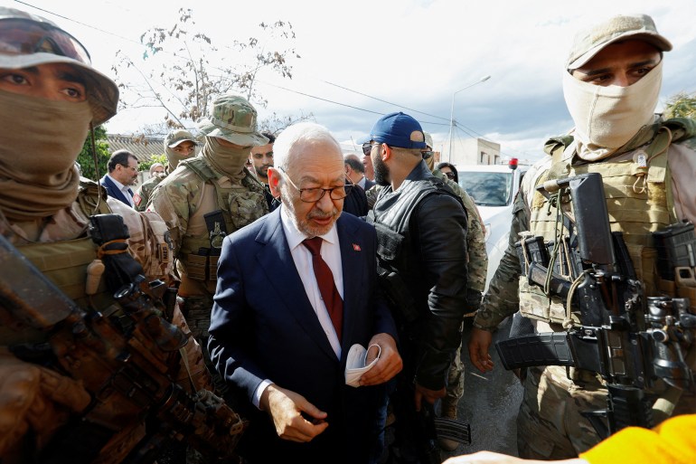 Tunisia's Rached Ghannouchi, head of the moderate Islamist Ennahda and speaker of the parliament, is surrounded by presidential guard members upon his arrival for questioning after he was summoned by Tunisian anti-terrorism police in Tunis, Tunisia April 1, 2022. REUTERS/Zoubeir Souissi