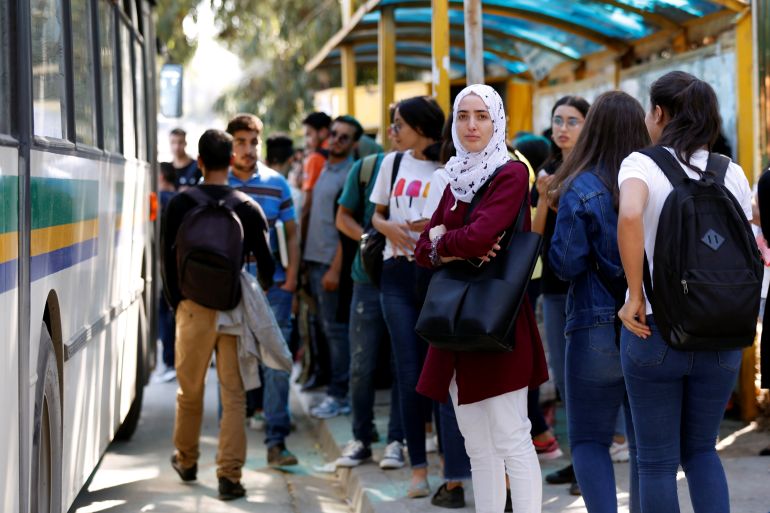 Youths wait for the bus outside Manar university in Tunis