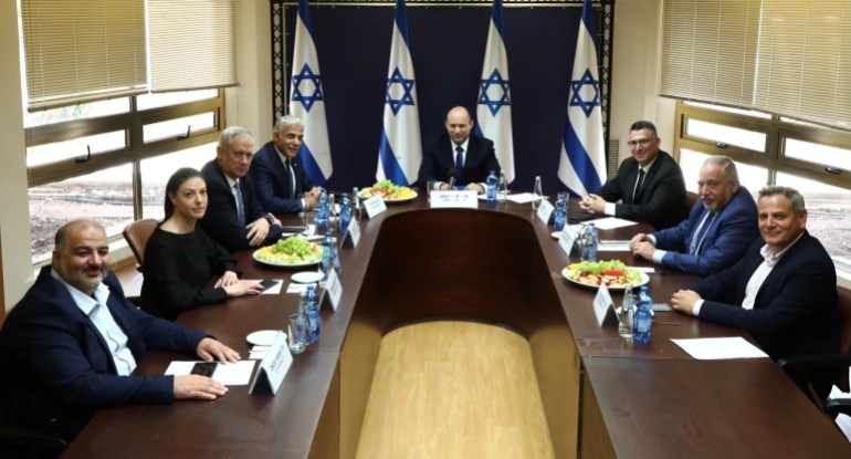 Party leaders of the proposed new coalition government, pose for a picture at the Knesset, Israel's parliament, before the start of a special session to approve and swear-in the coalition government, in Jerusalem