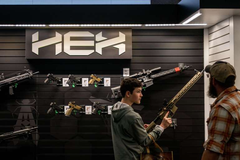 HOUSTON, TEXAS - MAY 27: A young boy examines a rifle at the George R. Brown Convention Center during the National Rifle Association (NRA) annual convention on May 27, 2022 in Houston, Texas. The annual National Rifle Association comes days after the mass shooting in Uvalde, Texas which left 19 students and 2 adults dead, with the gunman fatally shot by law enforcement officers. Brandon Bell/Getty Images/AFP== FOR NEWSPAPERS, INTERNET, TELCOS & TELEVISION USE ONLY ==