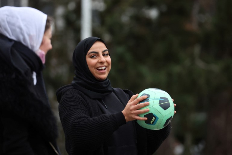 Supporters of Muslim women soccer players protest against French hijab ban in sports, in Lille Supporters of the women soccer team "Les Hijabeuses" play soccer in front of the city hall in Lille as part of a protest as French Senate examines a bill featuring controversial hijab ban in competitive sports in France, February 16, 2022. REUTERS/Pascal Rossignol