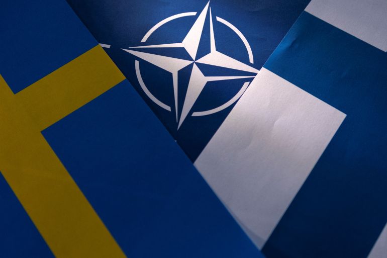 Illustration shows NATO, Swedish and Finnish flags