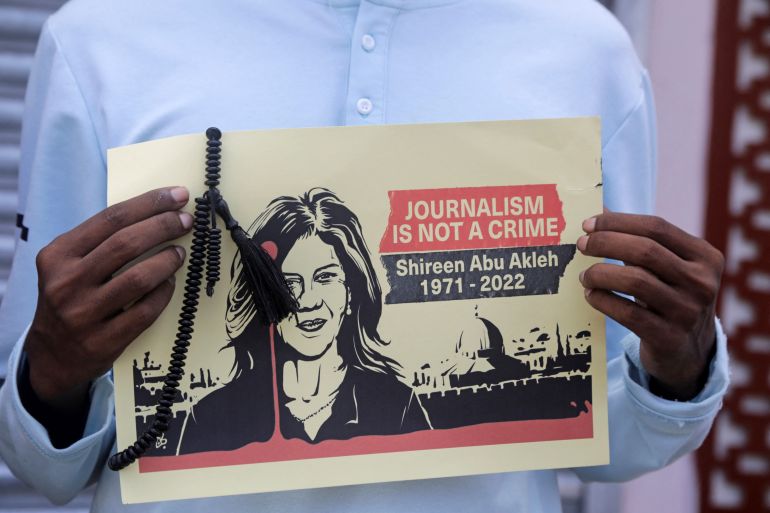 Journalists hold placards depicting Al Jazeera reporter Sireen Abu Akleh during a protest in Mogadishu