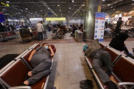 People wait at the Al Najaf International Airport, where flights have been halted due to a sandstorm