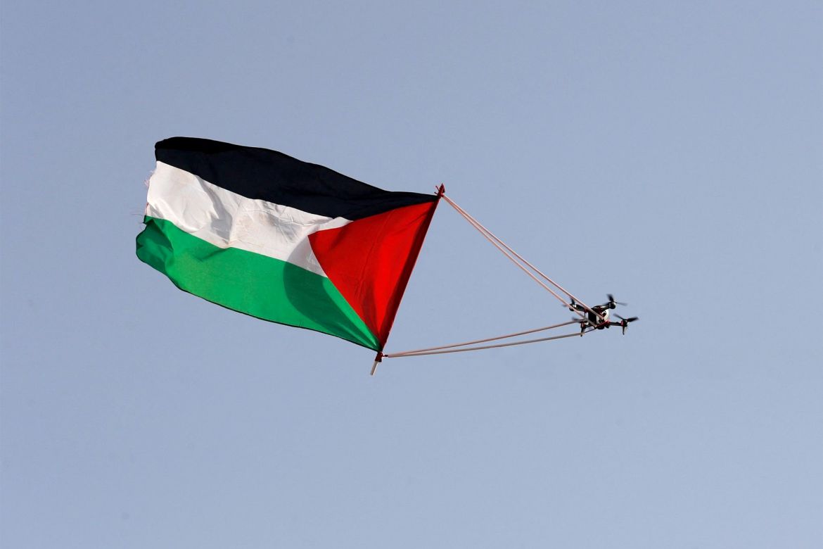 PALESTINIAN-ISRAEL-CONFLICT-JERUSALEM DAY A Palestinian flag hanging from a civilian drone flies over Jerusalem on May 29, 2022, during the Israeli 'flags march' to mark "Jerusalem Day". - Jerusalem is bracing for a controversial "flag march" by Israelis that has sparked warnings of a new escalation from Palestinian factions. (Photo by Ahmad GHARABLI / AFP) (Photo by AHMAD GHARABLI/AFP via Getty Images) gettyimages-1240979062