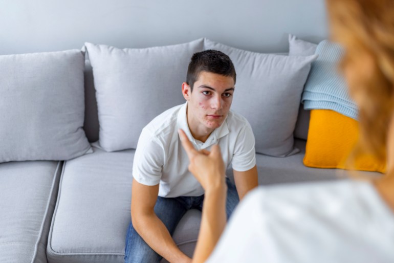 Mature Mother and her teenage son arguing at home while sitting on sofa. - stock photo Mother Arguing With Teenage Son Credit: ljubaphoto Creative #: 1348239310 Licence type: Royalty-free Collection: E+ Location: Serbia Release info: Model released