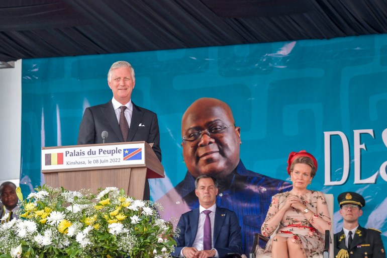 Belgium's King Philippe pauses during his address at the National Assembly in Kinshasa on June 8, 2022 as Belgium Queen Mathilde (R) and Belgium Prime Minister Alexandre De Croo look on. - Belgium's King Philippe, in a historic visit to DR Congo, said on June 8, 2022 that his country's rule over the vast central African country had inflicted pain and humiliation through a mixture of "paternalism, discrimination and racism." In a speech outside the Democratic Republic of Congo's parliament, Philippe amplified remorse he first voiced two years ago over Belgium's brutal colonial rule -- an era that historians say saw millions die. (Photo by Arsene Mpiana / AFP)