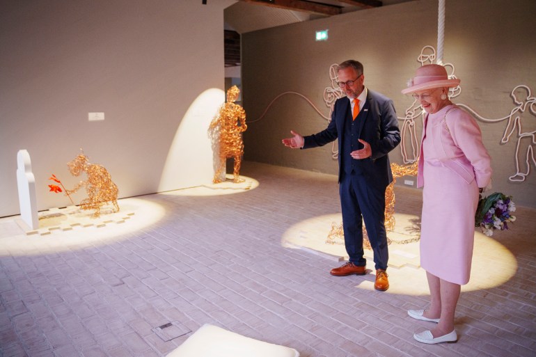 Danish Queen Margrethe (R) and museum director Claus Kjeld Jensen visit the exhibition during the inauguratio of the new Danish refugee museum FLUGT (escape) in Oksboel, Denmark, on June 25, 2022. (Photo by Bo Amstrup / Ritzau Scanpix / AFP) / Denmark OUT