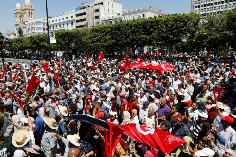 Demonstrators carry flags as they gather during a protest against Tunisian President Kais Saied in Tunis, Tunisia June 19, 2022. REUTERS/Zoubeir Souissi