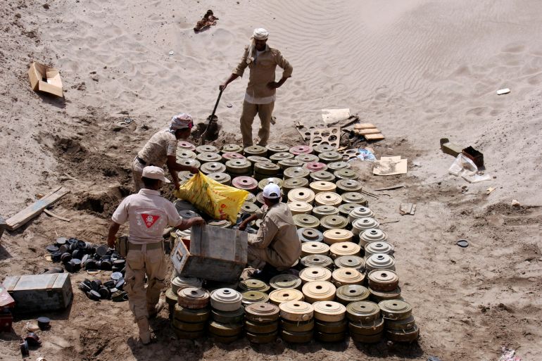 Members of a Yemeni military demining unit prepare to destroy unexploded bombs and mines collected from conflict areas near the southern port city of Aden, Yemen
